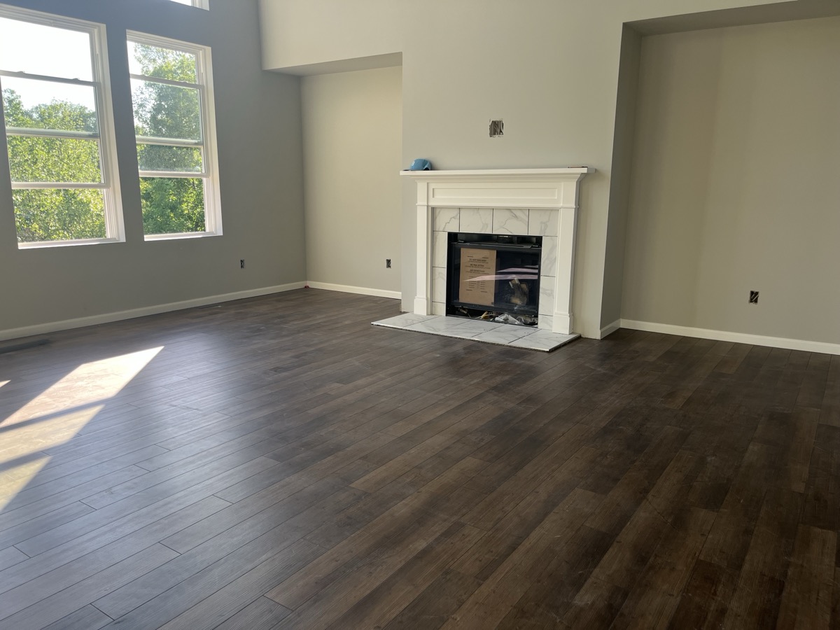 Dark hardwood flooring in living room with fireplace