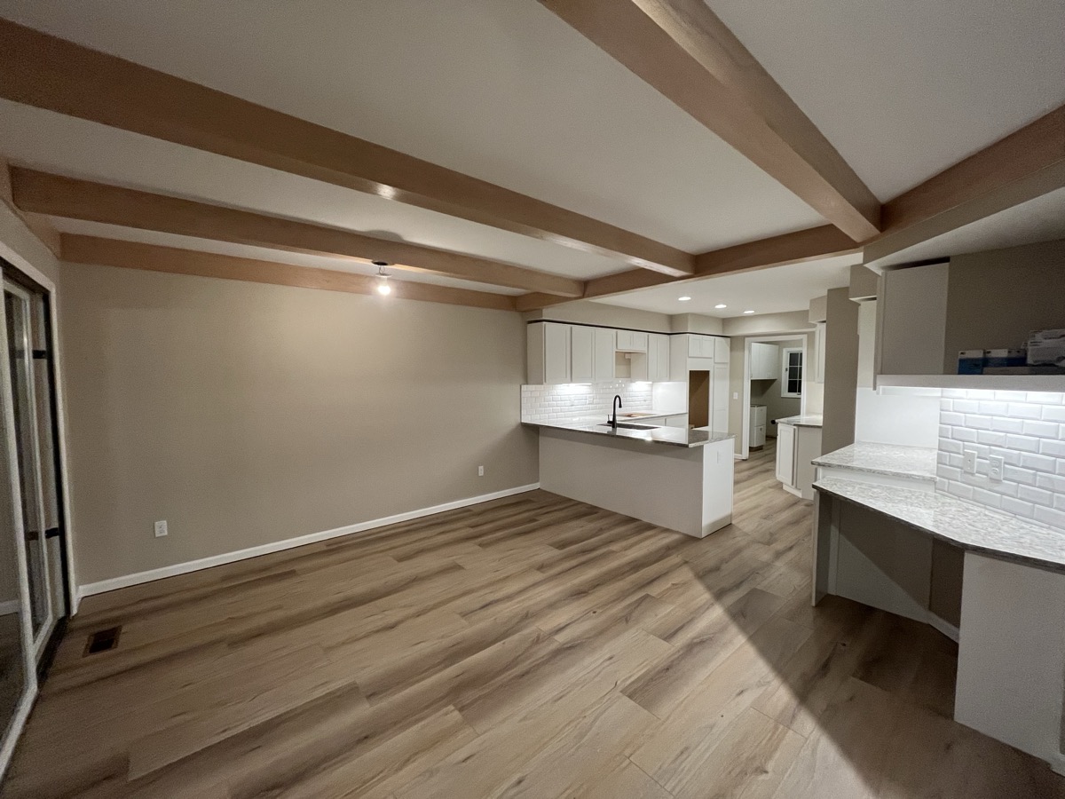 LVP flooring in kitchen with exposed beams