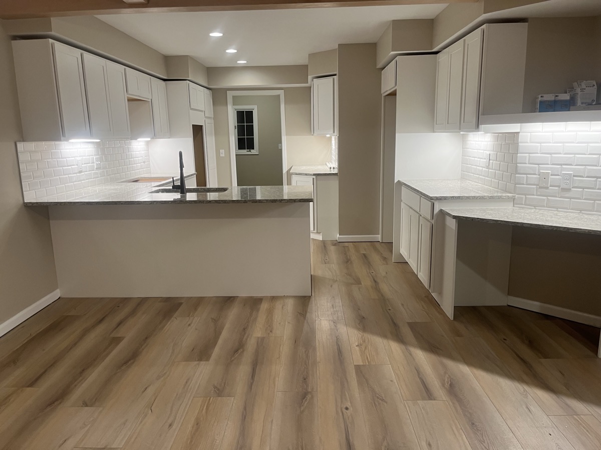 LVP flooring in modern kitchen with white cabinets